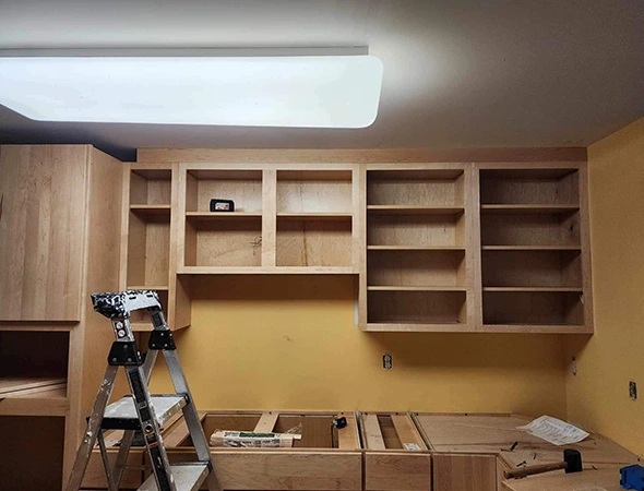 Custom wooden kitchen cabinets being installed by Kennison Construction during a home renovation project in Montpelier.